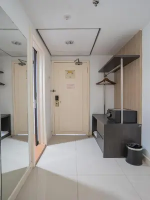 an empty room with a kitchen and a door at Floresta Hotel Chinatown in Kuala Lumpur