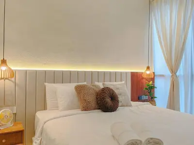 a bedroom with a white bed with white pillows at Scarletz Suites by Stevvy KL Home Stay in Kuala Lumpur