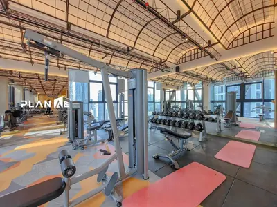 a gym with a lot of treadmills and machines at Scarletz Suites by Stevvy KL Home Stay in Kuala Lumpur