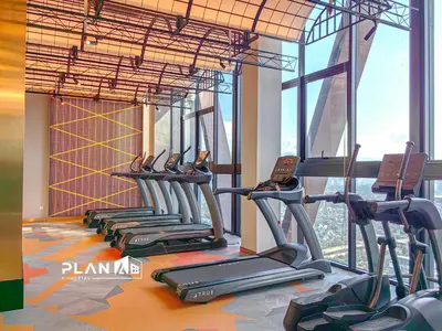 a row of cardio machines in a gym at Scarletz Suites by Stevvy KL Home Stay in Kuala Lumpur
