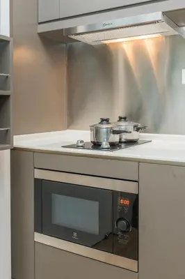 a kitchen with a stove with two pots on it at KLCC SkyTowerViewSuite AT CeylonzSuites in Kuala Lumpur