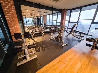 a gym with rows of chairs and a brick wall at Romantic Log Cabin - walk to KL Tower, KLCC, Bukit Bintang in Kuala Lumpur