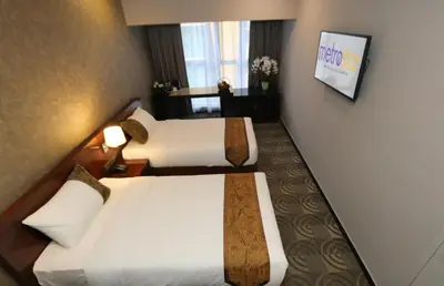 a hotel room with two beds and a window at Metrostar Hotel Kuala Lumpur in Kuala Lumpur