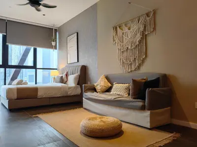 a living room with a couch and a bed at Scarletz Suites KLCC by De Harlequins Guesthouse in Kuala Lumpur