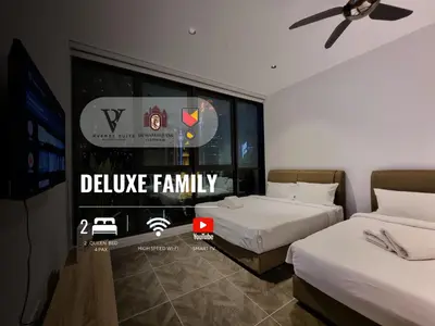 a bedroom with two beds and a tv and a window at Scarletz Suites KLCC by De Harlequins Guesthouse in Kuala Lumpur
