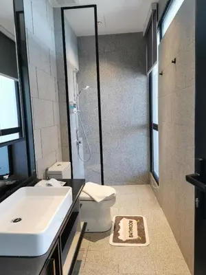 a bathroom with a sink and a toilet and a shower at Scarletz Suites KLCC by De Harlequins Guesthouse in Kuala Lumpur