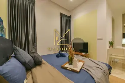 a bedroom with a bed with a table on it at Maxhome Plus at Lucentia Bukit Bintang City centre KL in Kuala Lumpur