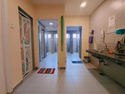 a hallway of a hospital with a door and a tile floor at SCC Hotel Chinatown in Kuala Lumpur