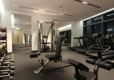 a gym with treadmills and machines in a room at Eaton Residences KLCC by WSD in Kuala Lumpur