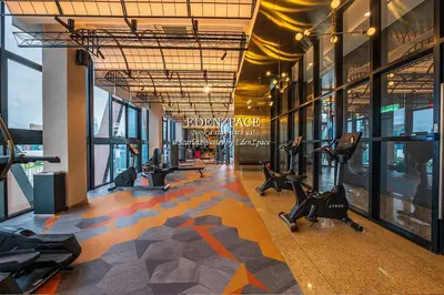 a gym with treadmills and ellipticals in a building at Scarletz Suites by Edenzpace @ KLCC Area in Kuala Lumpur