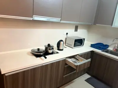 a kitchen with a stove and a microwave at Regalia Modern Studio in Kuala Lumpur
