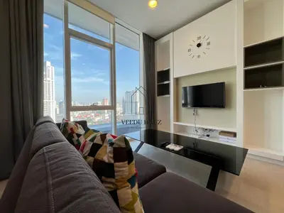 a living room with a couch and a large window at The Platinum KLCC by Veedu Hauz in Kuala Lumpur