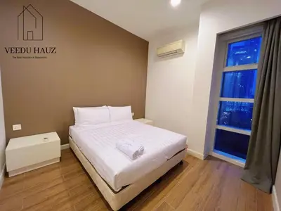 a bedroom with a bed and a sign on the wall at The Platinum KLCC by Veedu Hauz in Kuala Lumpur