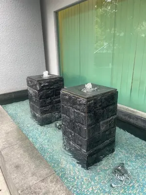 two brick boxes sitting on a floor next to a building at The Wisdom Apartment in Kuala Lumpur