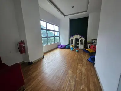 an empty living room with a large window at The Wisdom Apartment in Kuala Lumpur