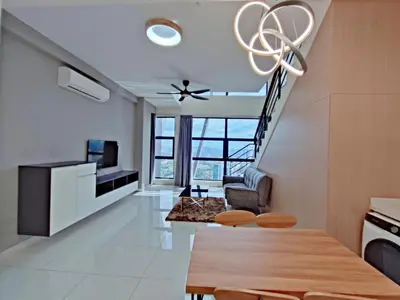a living room with a table and a chandelier at ARTE Mont Kiara Host By HOST CORNER SUITES in Kuala Lumpur