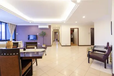 a living room with a couch and a table and chairs at Angkasa Impian 1 @ Bukit Bintang in Kuala Lumpur
