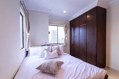 a bedroom with a large white bed with a window at Angkasa Impian 1 @ Bukit Bintang in Kuala Lumpur
