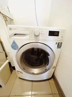 a washing machine in the corner of a room at [PROMO]Connected train 2 Bedroom (ABOVE MALL)15 in Kuala Lumpur