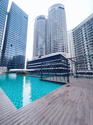 a boardwalk in front of a city with tall buildings at [PROMO]Connected train 2 Bedroom (ABOVE MALL)15 in Kuala Lumpur