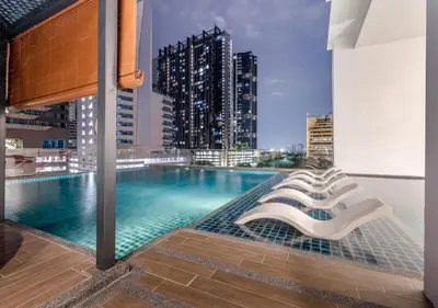 a swimming pool on the roof of a building with a city at Skyline Garden 2 Bedrooms Homestay Near KLCC in Kuala Lumpur