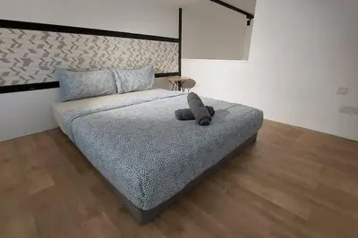 a bed with a stuffed animal on it in a room at KL Sentral, EST Bangsar #9, 4Pax in Kuala Lumpur