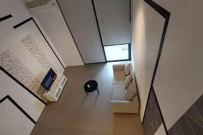an overhead view of a living room with a couch and a table at KL Sentral, EST Bangsar #9, 4Pax in Kuala Lumpur