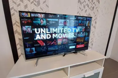 a large flat screen tv sitting on a white stand at KL Sentral, EST Bangsar #9, 4Pax in Kuala Lumpur