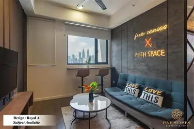 a living room with a blue couch and a window at Chambers Residence Kuala Lumpur by Roam in Kuala Lumpur