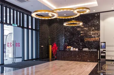 a lobby of a chanel store with a chandelier at Chambers Residence Kuala Lumpur by Roam in Kuala Lumpur