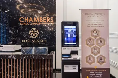 a prize machine next to a sign and a box at Chambers Residence Kuala Lumpur by Roam in Kuala Lumpur