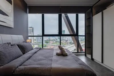 a large bed in a room with a large window at KLCC ModernMusicalSuite AT ScarletzSuites in Kuala Lumpur