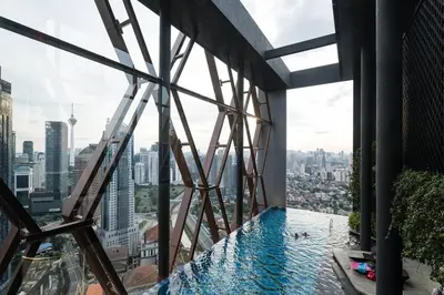 a swimming pool in a building with a view of the city at KLCC ModernMusicalSuite AT ScarletzSuites in Kuala Lumpur