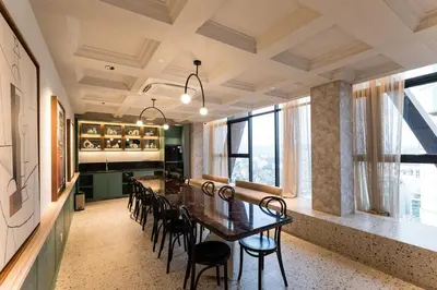 a dining room with a long table and chairs at KLCC ModernMusicalSuite AT ScarletzSuites in Kuala Lumpur