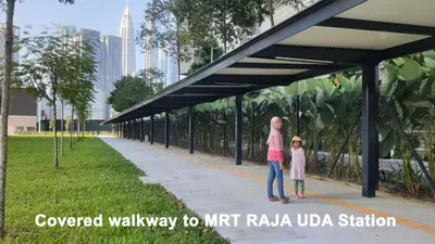 a man and a little girl standing under a bridge at Homestay Jalan Tun Razak walking distance IJN, HKL, MRT Raja Uda, PUSRAWI, KPJ, PERKESO, Istana Budaya Гостевой дом Куала-Лумпур โฮมสเตย์ กัวลาลัมเปอร์ in Kuala Lumpur