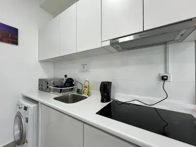 a kitchen with a sink and a microwave at Arte plus by Sweet home in Kuala Lumpur