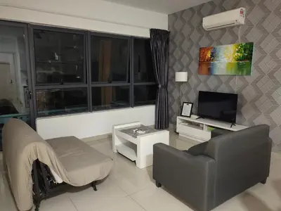 a living room with a couch and a chair and a television at Arte plus by Sweet home in Kuala Lumpur