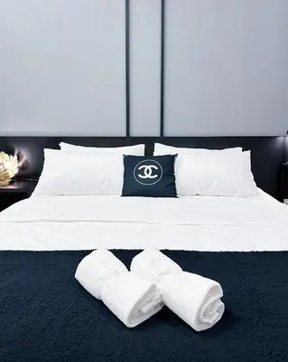 a bed with white pillows and white socks on it at Tropicana The Residence suites by VV Homestay KLCC in Kuala Lumpur