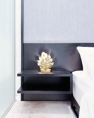 a nightstand with a plant on it next to a bed at Tropicana The Residence suites by VV Homestay KLCC in Kuala Lumpur