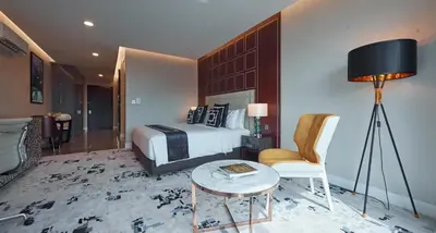 a hotel room with a bed and a table and a chair at THE FACE Style Hotel in Kuala Lumpur