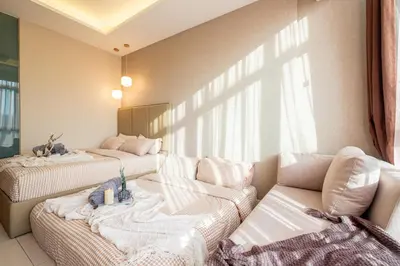 a living room with two beds and a couch at Dorsett Residences Hartamas Kuala Lumpur by Feel Home in Kuala Lumpur