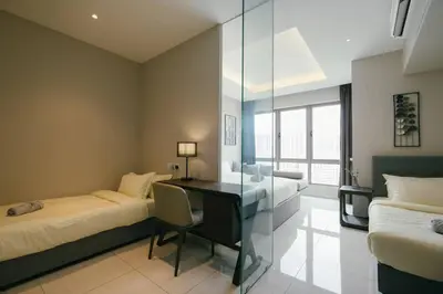 a bedroom with a desk and a bed and a desk at Dorsett Residences Hartamas Kuala Lumpur by Feel Home in Kuala Lumpur