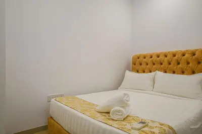 a bedroom with a bed with white towels on it at Eaton Residence KLCC Skyline in Kuala Lumpur