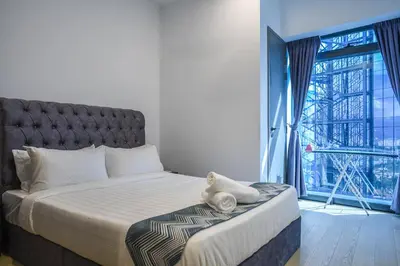 a bedroom with a large bed and a large window at Eaton Residence KLCC Skyline in Kuala Lumpur