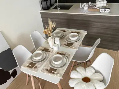 a dining room table with white chairs and a table with a flower at INS Style 5PAX 2R2B Sunway Velocity Linked in Kuala Lumpur