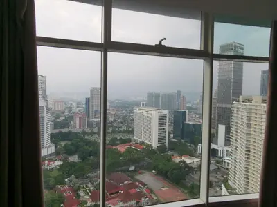 a view of a city from a window at Vortex Suites KLCC by C&C Fortune in Kuala Lumpur