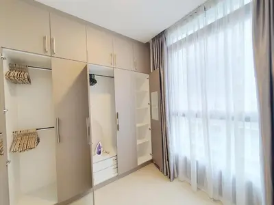 a bedroom with a large window and white cabinets at Arcoris Mont Kiara Kuala Lumpur in Kuala Lumpur