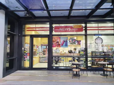 a store front with tables and chairs in a store at Arcoris Mont Kiara Kuala Lumpur in Kuala Lumpur