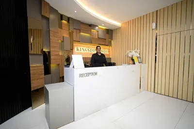 a man sitting at a counter in a restaurant at Kingston Hotel 5 - Chow Kit in Kuala Lumpur