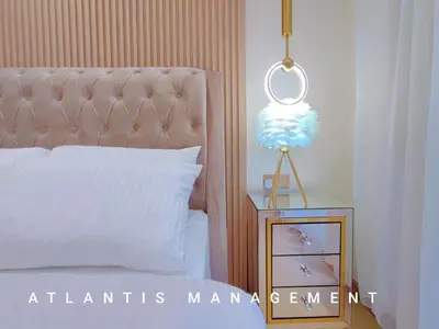a bedroom with a bed and a night stand with a lamp at Arte Mont Kiara, Private Elegant Suite manage by Atlantis Management in Kuala Lumpur